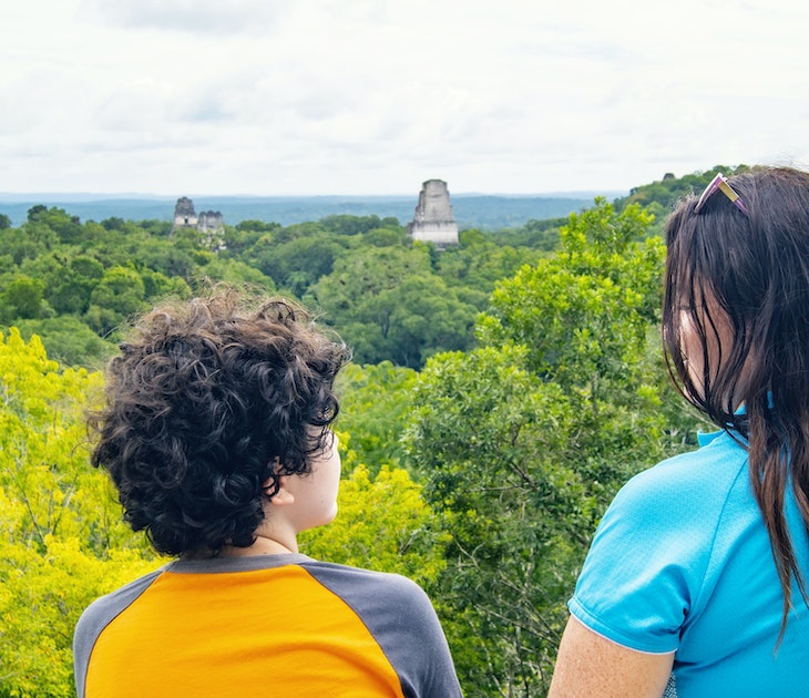 Rear view of curly hair boy and his mother in front of landscape in Tikal: rainforest and mayan pyramids.   .The Tikal National Park in Guatemala protects a large tropical forest of 576 km2, in it is the largest archaeological site in America: Tikal (which means "Place of Voices") and is one of the largest Mayan cities known today with more than 3,000 archaeological elements. It was declared a World Cultural and Natural World Heritage Site in 1979.
1148504527
temple i