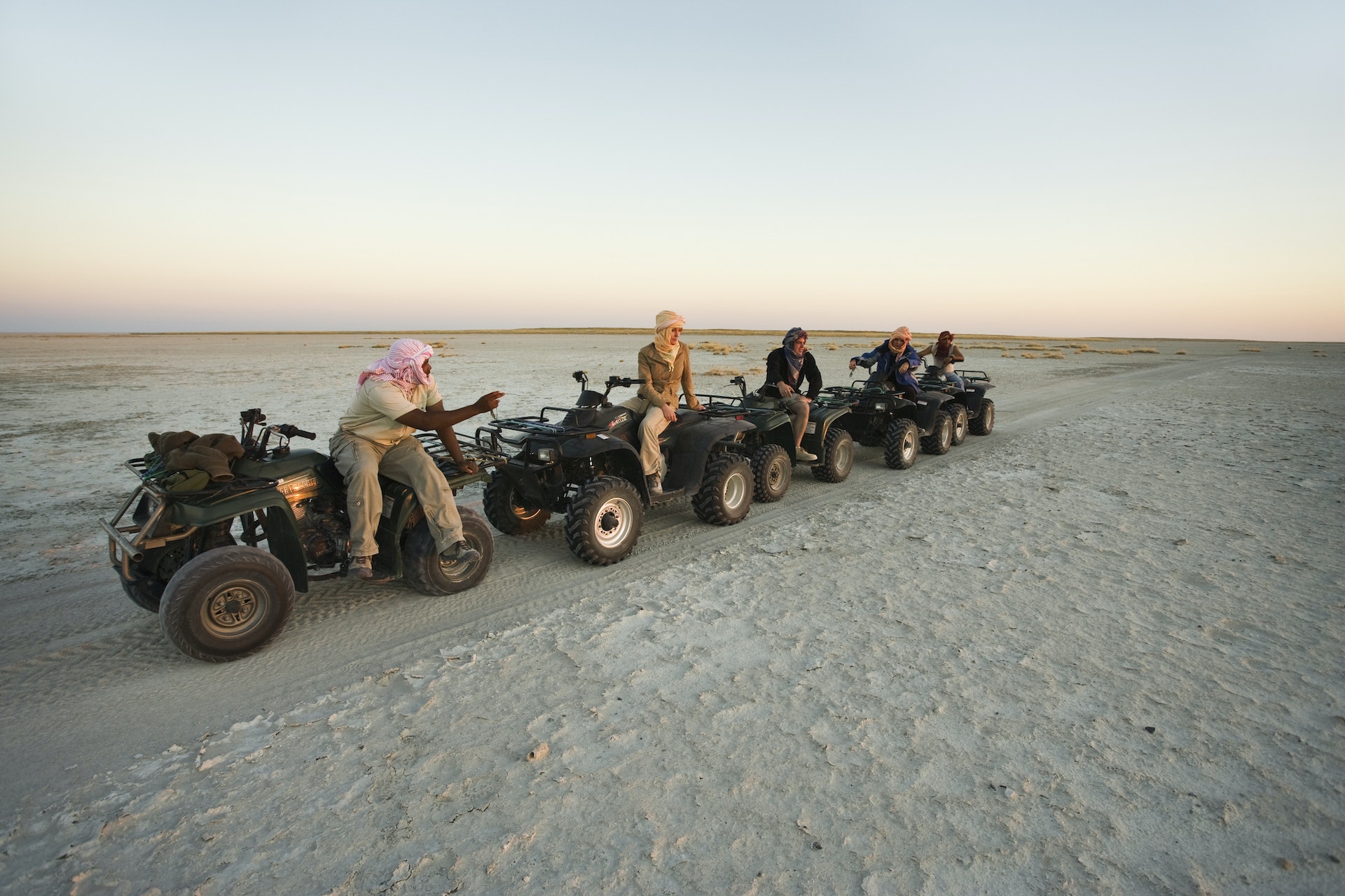 Tourists explore the salt flats of Makgadikgadi Pans on quad bikes, which are permitted on the fragile plains in single file only.