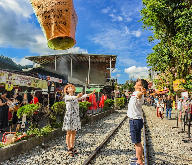 Tourists launching sky lanterns along the Pingxi Railway line near Taipei